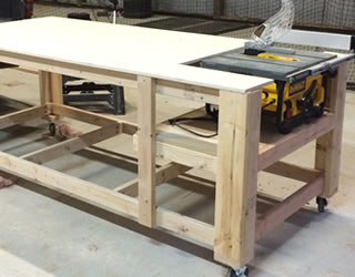 A modest garage workshop with a workbench, circular saw, and basic hand tools